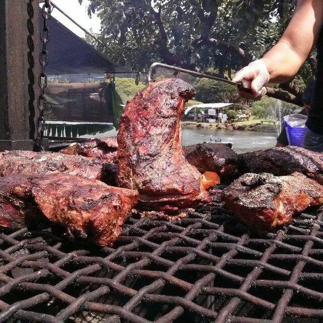 Tri-tip cooking over the Paniolo barbecue pit